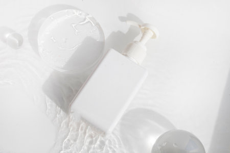 makeup cosmetic medical skin care, a mockup for cream lotion bottle product, packaging on white  waterdrop fresh with glass backgroundの写真素材