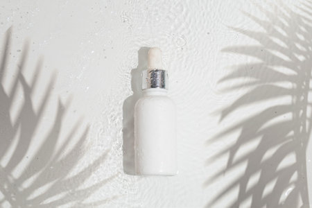 makeup cosmetic skin care, a mockup for cream lotion bottle product, packaging on white waterdrop fresh with glass backgroundの写真素材