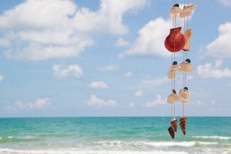 Summer sky and beautiful beach with hanging seashellsの写真素材