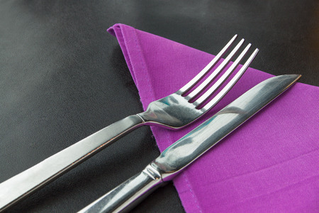 Knife and fork with violet napkinの写真素材