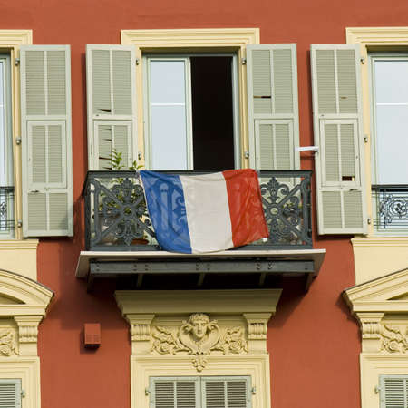 typical front of house in Nice with french flag on a balconyの写真素材