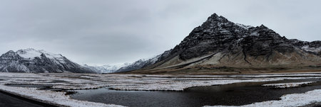 Beautiful panoramic winter landscape view of Iceland, snow capped on the mountains.