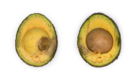 Slowly decaying avocado slices against white background
