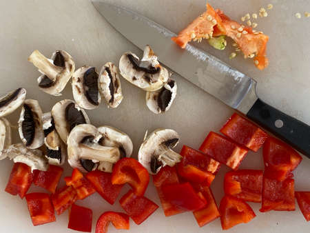 Red Peppers and mushrooms cutted on the desk in a kitchenの写真素材