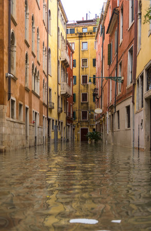 Venice, Italy - November 1, 2018: acqua alta, view on a street has been flooded by waters rising 156 cmのeditorial素材
