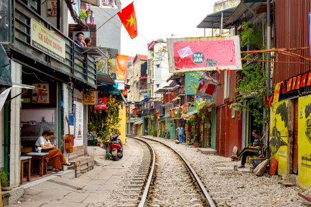 Hanoi, Vietnam, December 30, 2019 : Train Street in Hanoi. Attraction where tourists can watch a train speeding by along a cramped thoroughfare. Street has many shops and cafes.のeditorial素材