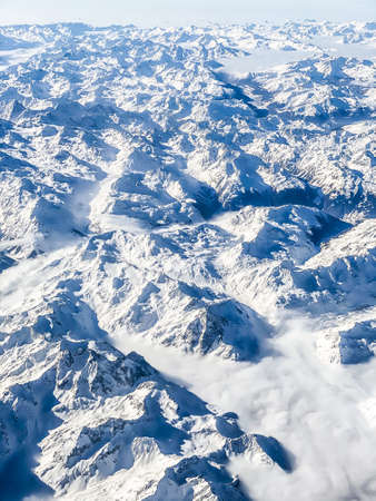 aerial view of the alps covered of snow during winterの写真素材