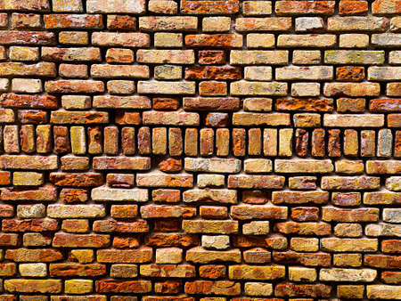 Horizontal part of a Venetian old red brick wall, background,の写真素材