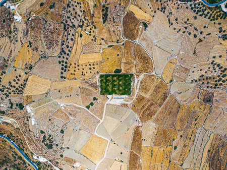 Aerial view on a green football field during drought on sifnos island, Greeceの写真素材