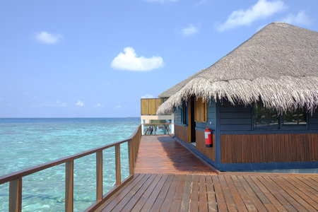 Beyond the bungalows the sea stretches on forever. Maldives Islands.の写真素材