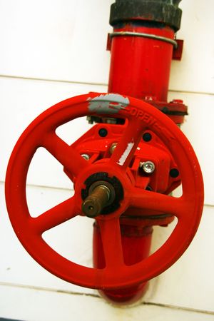 part of red fire extinguisher in main buildingの写真素材