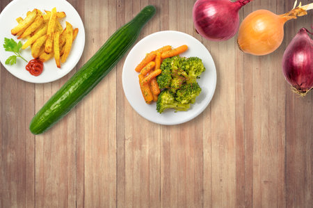 French fries and vegetable salad. Cucumber and onions.の写真素材