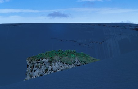 Landscape with only one seagull on a single rock in a black dunes desertの写真素材