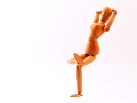 Wood made artist's dummy in relaxing poseの写真素材