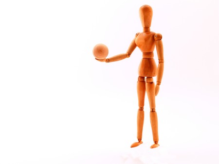 Wood made artist's model with a ball in the handの写真素材