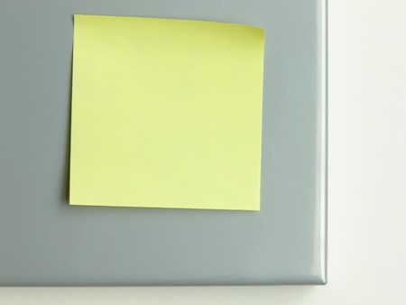 Close up picture of a yellow postit on metal backgroundの写真素材