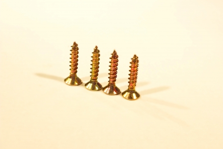 Macro view of shiny metal bolts and nuts isolated on whiteの写真素材