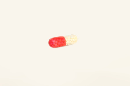 Assortment of pills, tablets and capsules on on a white background