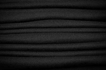 Many of black shirt background. Dark textile material.の写真素材