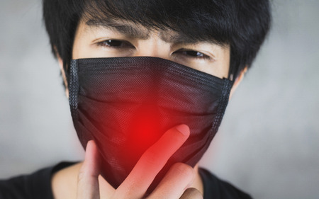 Portrait of man wearing pollution prevention or flu mask with danger.