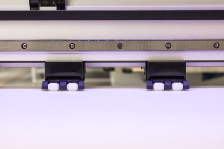 Blank paper roll and wheel in large printer format inkjet machine for industrial business.の写真素材