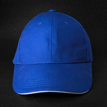 Blue cap dark background. Template of baseball cap in front view.の写真素材