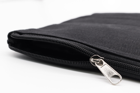 Black zipper fabric bag open on white background.