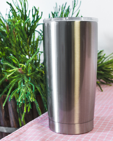 Steel bottle on kitchen table background. Blank drink mug for design.の写真素材