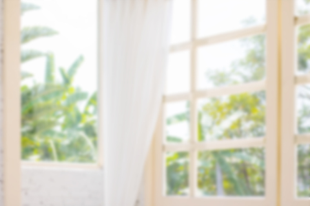 Defocused window background with white curtains in morning time.の写真素材