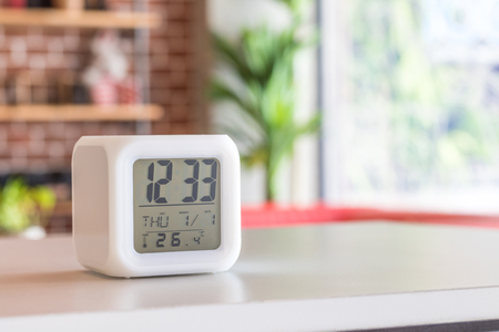 LED alarm clock standing on table background. Digital timer display. Copyspace for your design.の写真素材