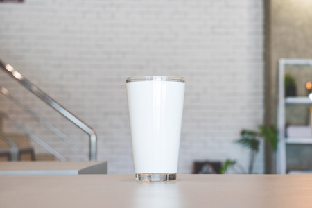 Tall glass and modern room background. Transparent drink mug or glassware for your design. Can put text, image, and logo.の写真素材