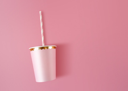 Paper cup with straws on pink background. Pink cups made from cardboard for party style.の写真素材