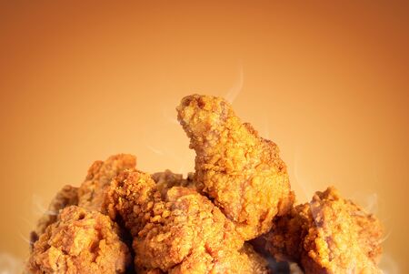 Fried chicken or crispy kentucky on brown background. Delicious hot meal with fast food.の写真素材