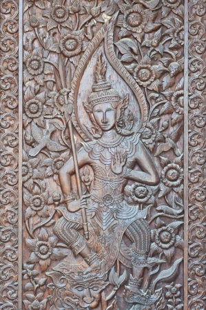 Angel woodcraft on temple door の写真素材