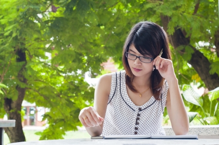 Beautiful Asian student woman solve a problem の写真素材