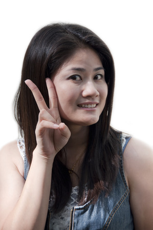 Beautiful Asian woman with victory hand-sign の写真素材