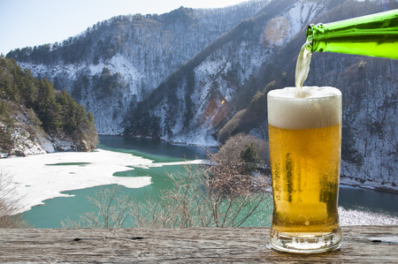 Enjoy beer with Japan mountain and river landscape in winter.の写真素材