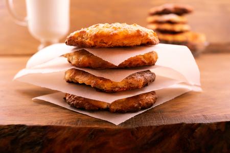 Cookies with cottage cheese, baked until golden brown, shifted thin paper, wooden background.の写真素材