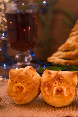 Two heads of puff pastry pigs-symbols of 2019, a glass of mint tea, vertical frame.の写真素材