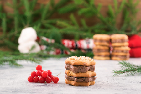 Sweet dessert for Christmas holidays-puff pastry with chocolate filling, viburnum berries, fir branches with green needles.の写真素材