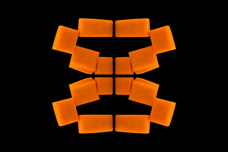 Abstract pattern of orange cubes on black background.