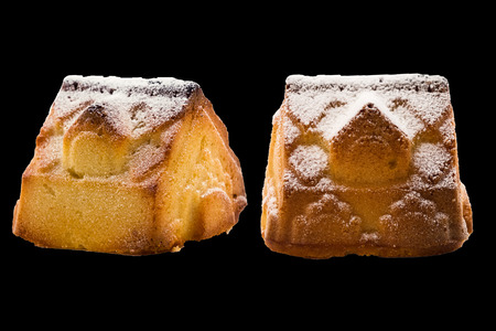Cookies with powdered sugar. House under the snow. New Year's decoration. Isolated on black background.の写真素材