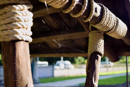 Wooden stick, coils of thick rope. The cable mount. Thin cobwebs.の写真素材