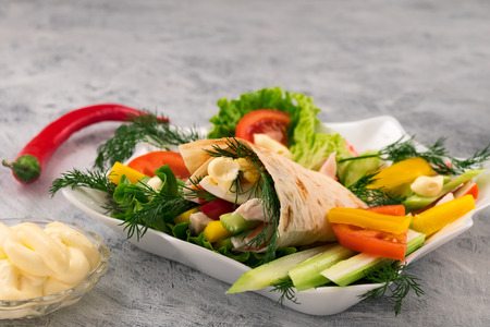 Roll with boiled meat and egg, sliced â€‹â€‹pepper with lettuce and dill. Burrito with...
