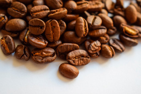 Roasted coffee beans on white background. Close up. Selective focus.の写真素材