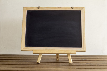 blank small blackboard on the wooden tableの写真素材