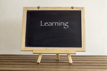 blank small blackboard on the wooden tableの写真素材