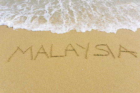 Drawing MALAYSIA on the sandの写真素材