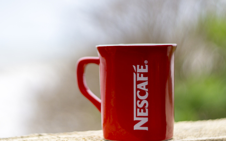 TERENGGANU, MALAYSIA - 09/02/2016 : Outdoor shot of a red Nescafe cup, background blur.のeditorial素材