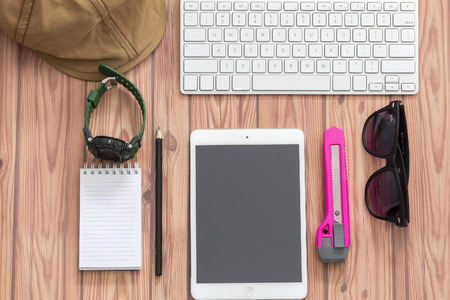 KUALA LUMPUR, MALAYSIA - JUNE 22, 2016 : keyboard, sanglass, ipad, watch, cap and note book. Travel Concept.のeditorial素材